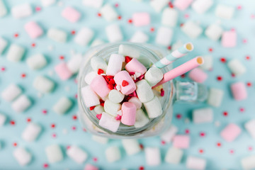 Milk  shake with Marshmallows  in a glass jar on a blue background