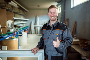 Worker in workshop for manufacture of windows and doors