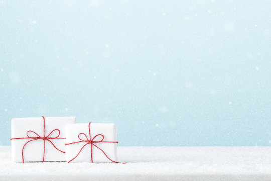 Christmas holiday background with white gift boxes  on a blue background.