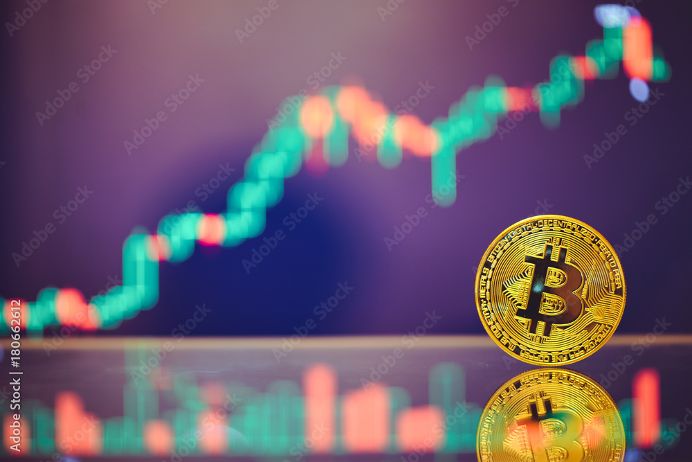 Poster bitcoin is a gold coin and a defocused graphics background. on the graph growth. the concept of virt