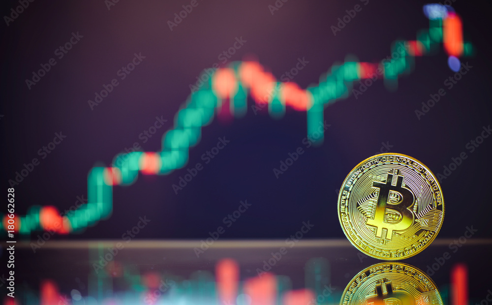 Poster bitcoin is a gold coin and a defocused graphics background. on the graph growth. the concept of virt