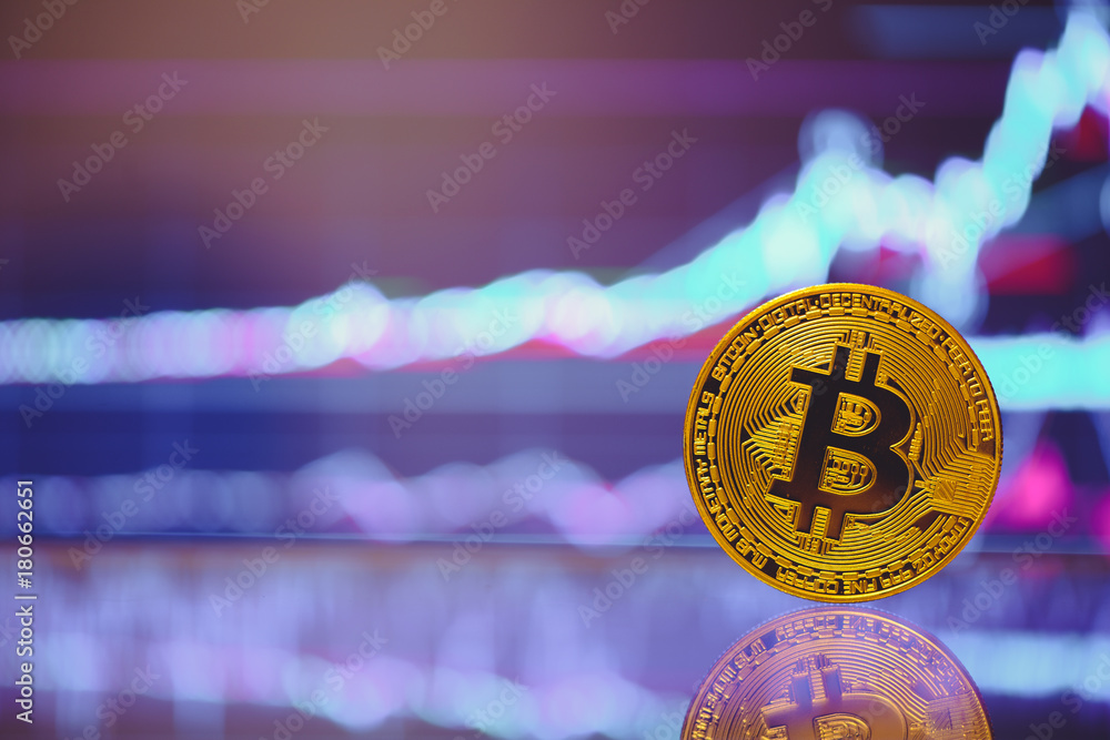Poster bitcoin is a gold coin and a defocused graphics background. on the graph growth. the concept of virt