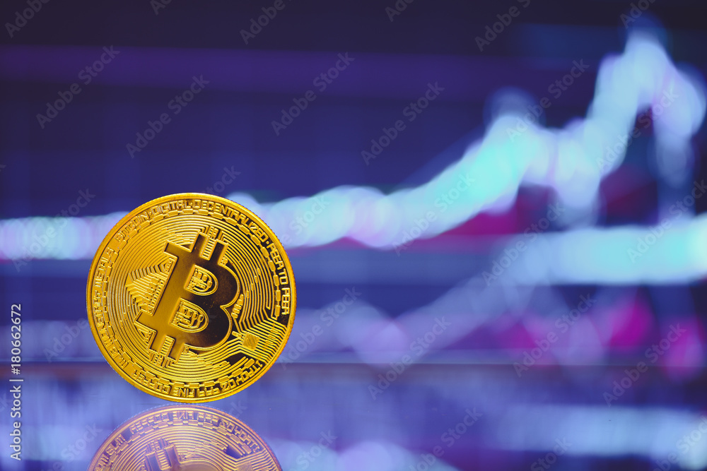 Poster bitcoin is a gold coin and a defocused graphics background. on the graph growth. the concept of virt