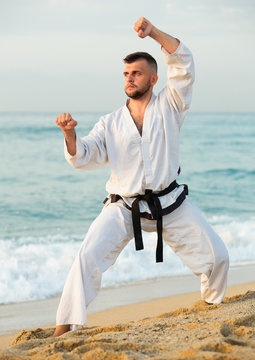 Sport guy practising karate kata poses