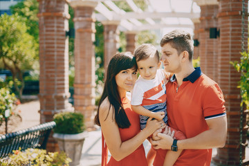 beautiful family in red walking down the street and the Park