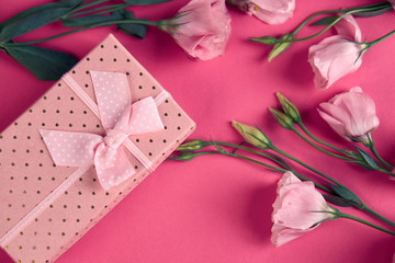 flowers on a pink background and a gift