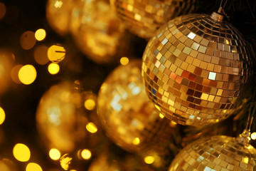 close up mirror ball or Christmas ball to decorative for Christmas festival with bokeh golden tonebackground. Have some space for write wording
