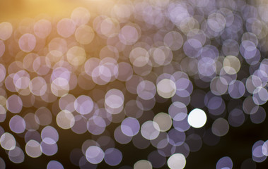 Abstract defocused of purple light on orange light shine background
