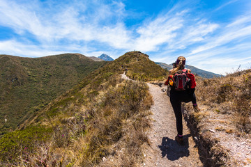 A woman climber takes photos of the Andean landscape