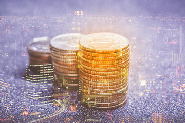 Double exposure of American dollar coins stack with cityscape. use for financial and banking concept
