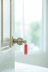 Red key tag with opened door