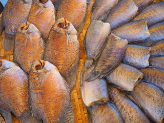 One sunny fish on a wooden tray.
