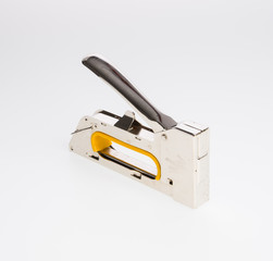 stapler or furniture stapler on a background.