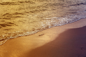 Soft and clean white wave of the sea on the sandy beach for summer nature background