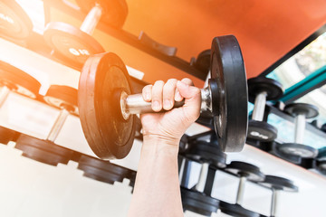 Rows of dumbbells in the gym with hign contrast and monochrome color tone