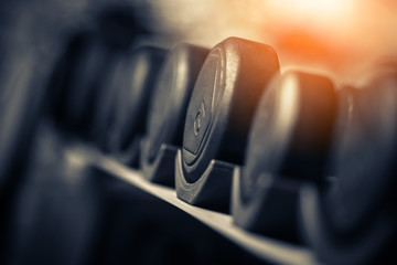 Rows of dumbbells in the gym with hign contrast and  color tone sport and health concept