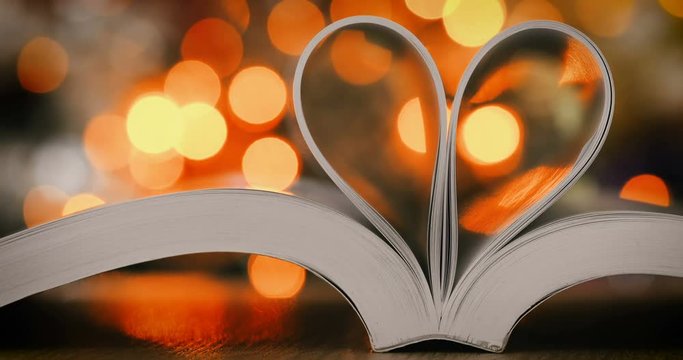 Book page decorate to heart shape with celebration bokeh light for love and romance of valentines day concept , 4K Dci resolution