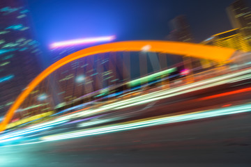 Fototapeta premium light trails through the steel bridge in the downtown district