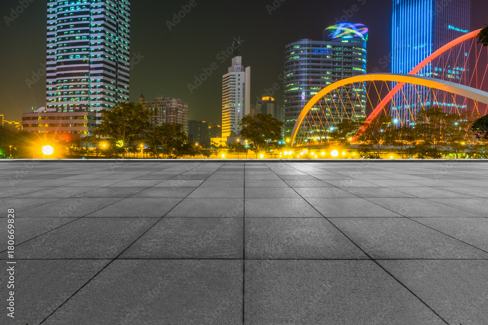 Wall mural night view of empty brick floor front of modern building