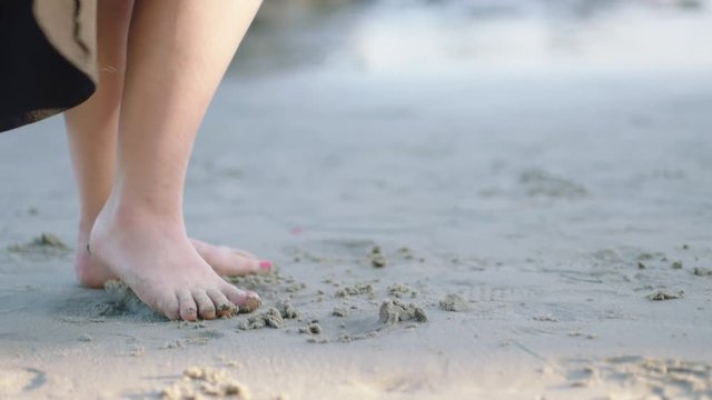 A woman's feet walking at the beach