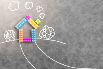 colorful toy house on grey leather texture background with children style drawing