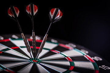 red three darts arrows in the target center