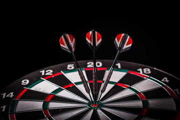 red three darts arrows in the target center