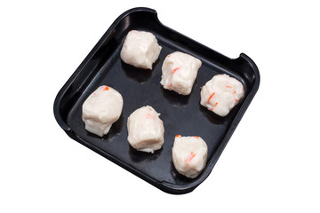 fresh fish balls on black plate