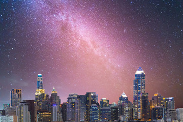 Milky way galaxy with stars and space dust in the universe over the night city