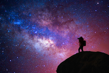 Silhouette of a camera girl who shooting a milky way