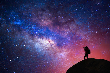 Silhouette of a camera girl who shooting a milky way