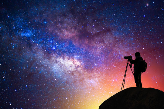 milky way, star, silhouette happy camera man on the mountain with detail of the milky way