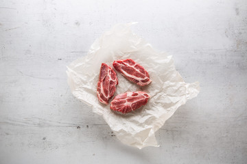 Pork meat. Pork slieces on white conkrete background