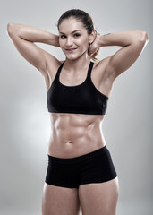 Fototapeta premium Fitness woman posing in gym outfit