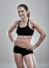 Fototapeta na wymiar Fitness woman posing in gym outfit