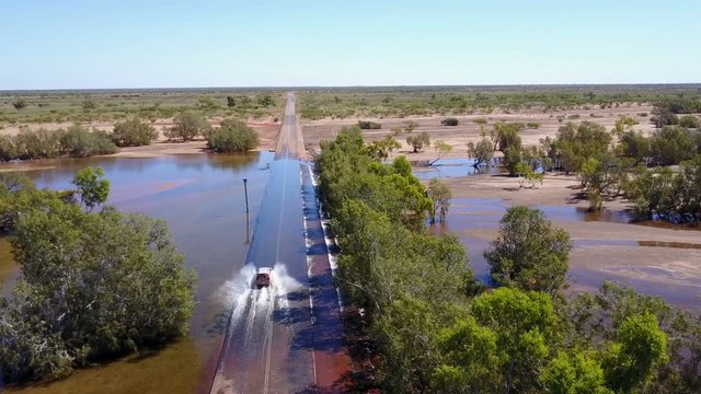 Car crossing a river during adventure road trip