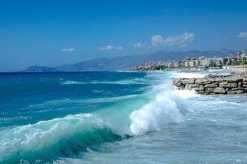 Waves break about a stone pier