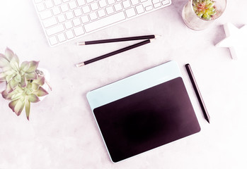 Top view flat lay graphic tablet on grey office table. Modern designer's work place concept. Text space