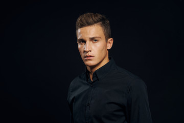 man in black shirt on black background
