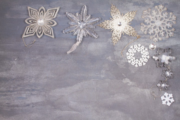 Christmas and New Year snowflakes border or frame on gray background. Winter holidays concept. View from above, top studio shot, horizontal