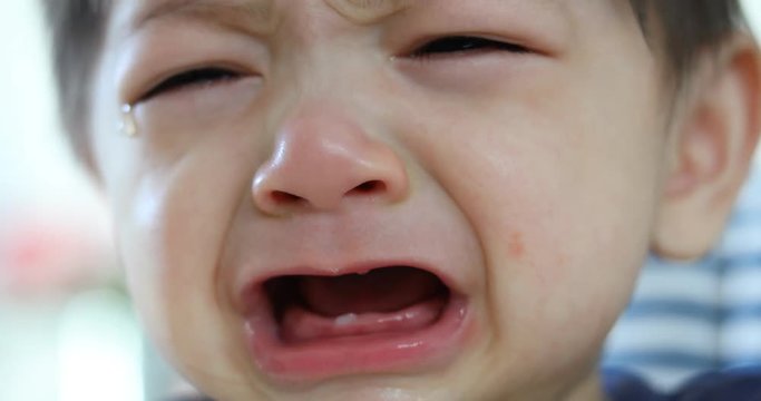 baby boy crying with tears unhappy feeling