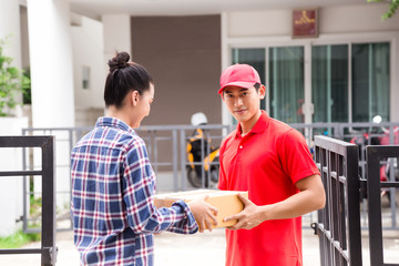 Fototapeta premium Woman accepting a delivery of boxes from delivery service courier. Isolated on a White Background.