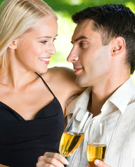 Young happy couple with champagne, outdoor