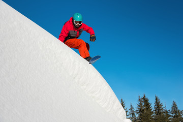 Shot of a snowboarder riding on dangerous slope on sunny winther day in the mountains copyspace...