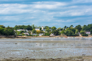Brittany, Ile aux Moines island, beach, low tide, panorama of the village and the church 
