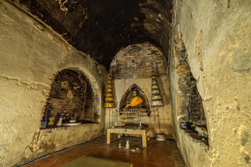 Buddha statue in the old cave of Wat Umong Suan Puthatham Temple in Chiang Mai province, Thailand....