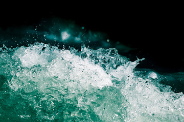 Splash of stormy water in the ocean on a black background