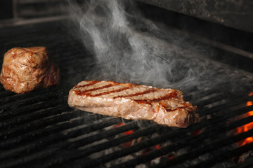 Beef steak medium roast cooking on grill, preparing meat