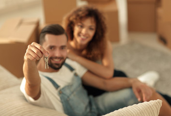 Young couple with a key to a new apartment.