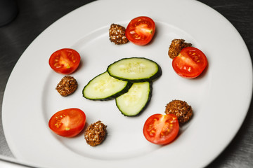 Preparation of salad with cucumbers, and cherry tomatoes